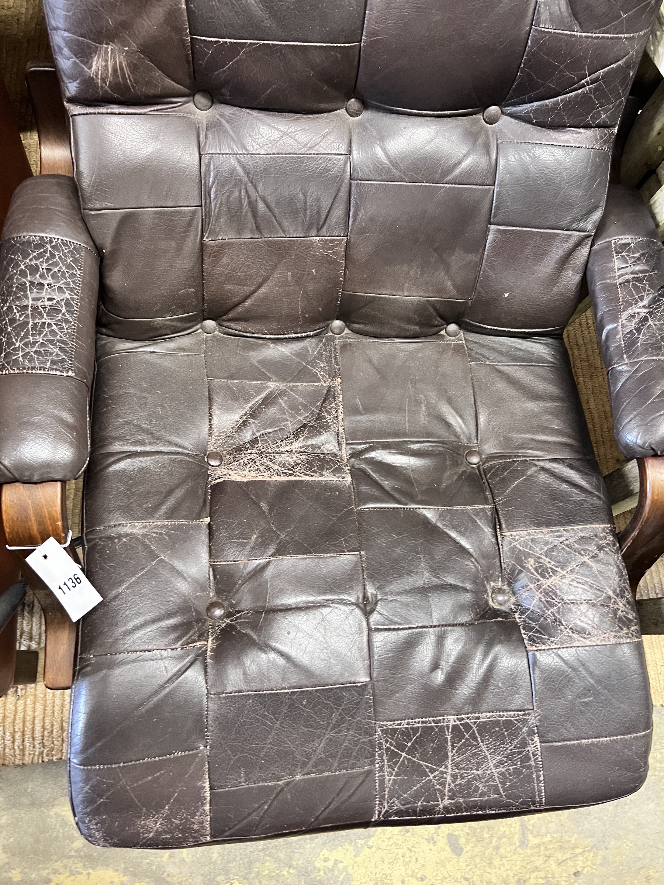 A Danish mid century leather upholstered swivel reclining armchair